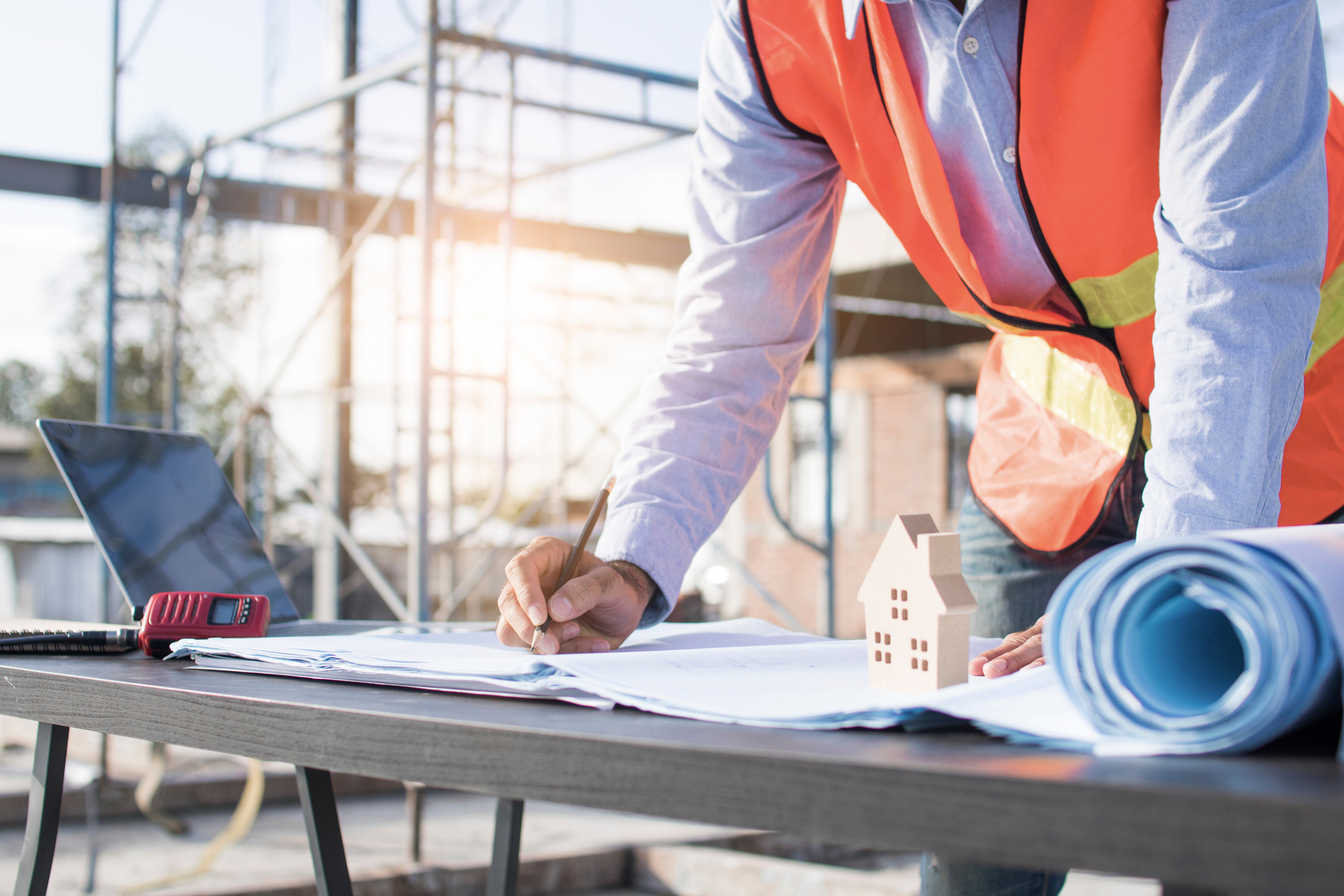 Engineer Planing and Working on Table in Construction Working Si